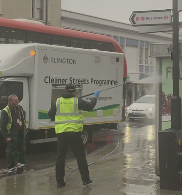 Islington council workers jetwash street furniture at Archway 19/03/2020